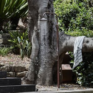 Stylish copper outdoor shower in a garden Stylish copper outdoor shower in a garden