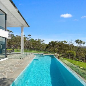 Modern swimming pool surrounded by greenery